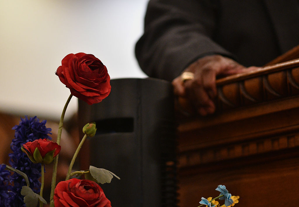 Flowers sit next to a podium